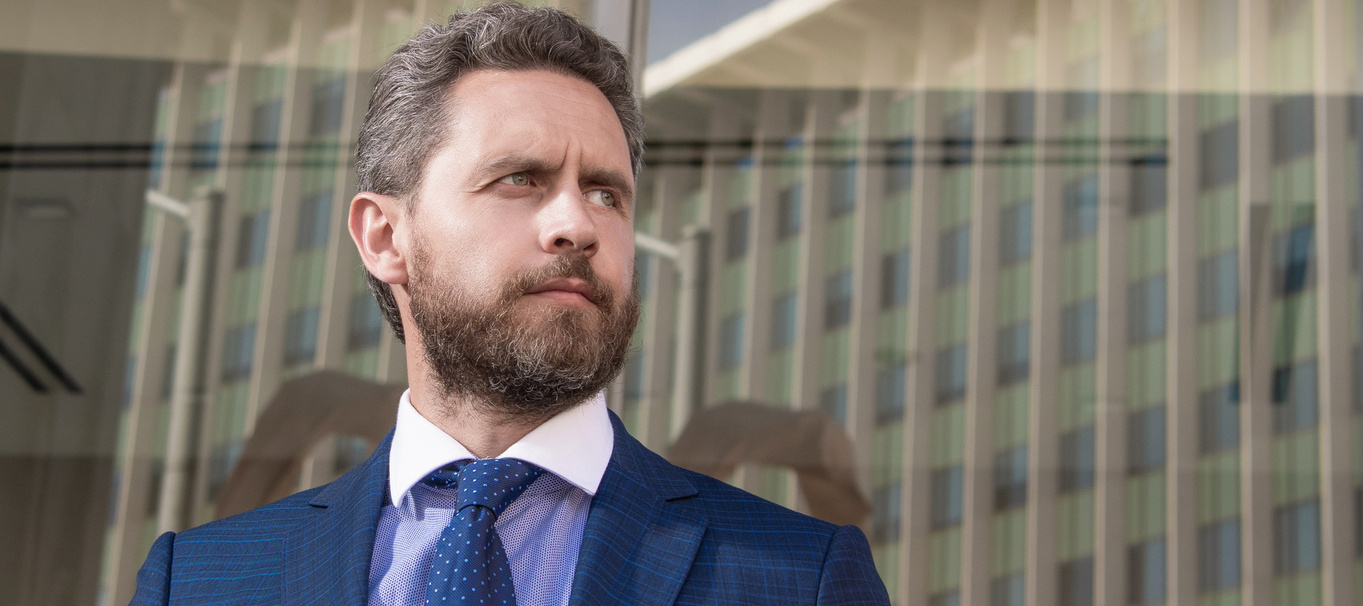 Man face portrait, banner with copy space. Business man in suit, office background. successful man in businesslike suit. manager executive outside the office. male formal fashion.